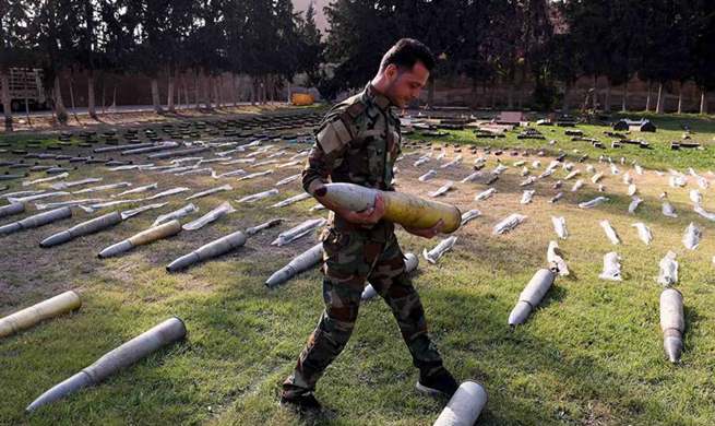 Syrian army confiscate weapons found in formerly rebel-held areas in Syria